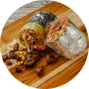 A mouthwatering burrito on a wooden cutting board at a Mexican franchise.